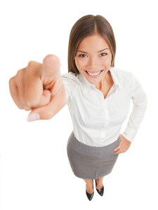 Positive business woman pointing her finger at camera isolated o